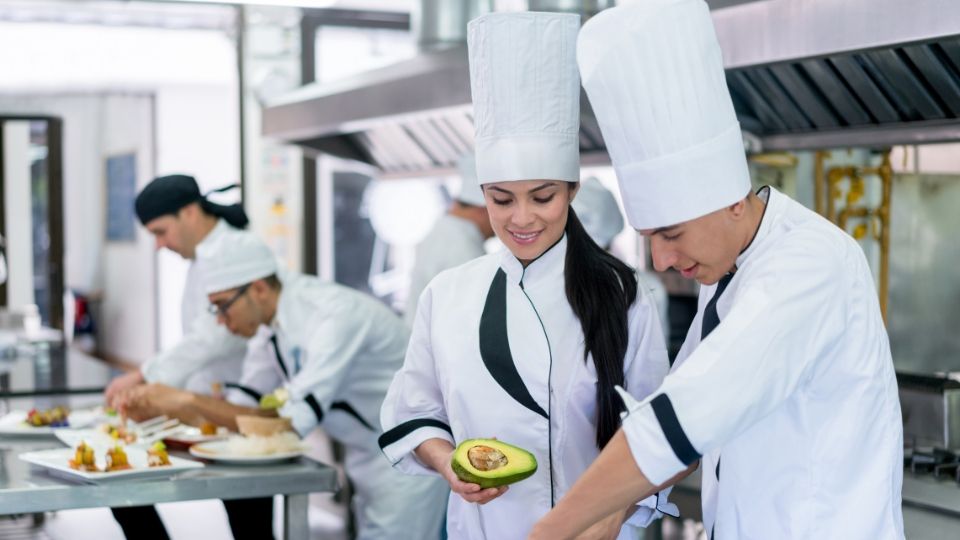 chef de partie with colleagues in a kitchen